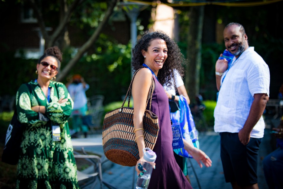 A photo of Nehad walking in the festival courtyard, she is smiling at the camera.