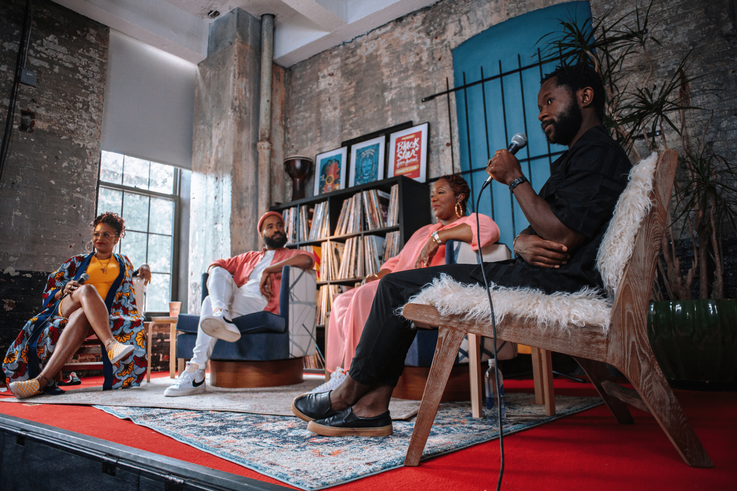 A photo of Maori Karmael Holmes, Rashid Zakat and two guests tapping an episode of The Daily Jawn. They are all seated, the person on the far right is holding a microphone.