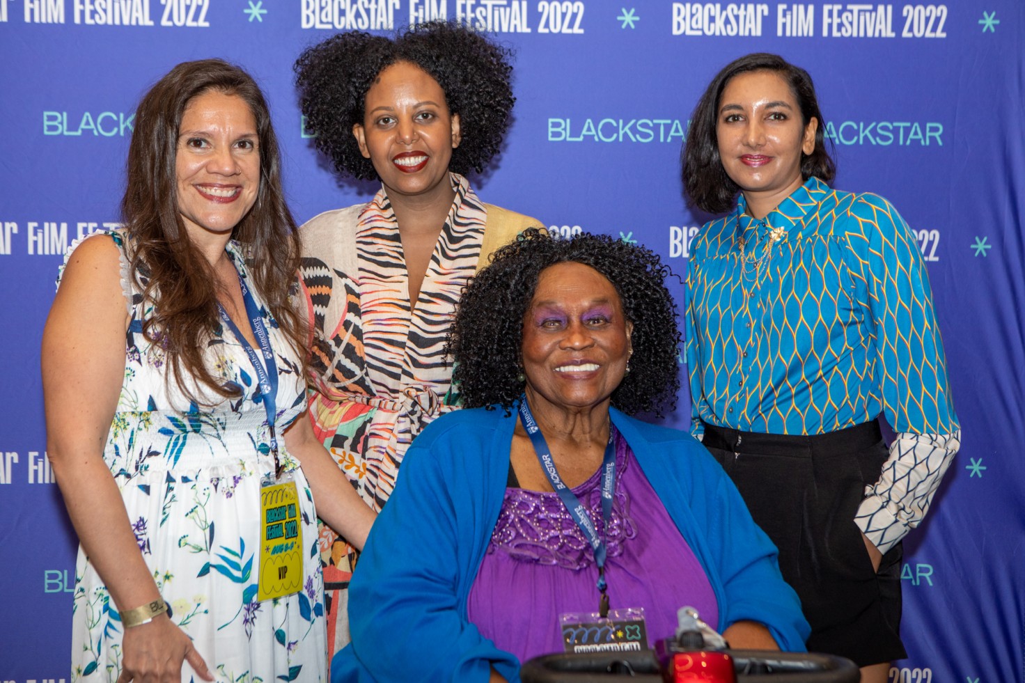 A photo of four people in front of the BlackStar step-and-repeat smiling at the camera.
