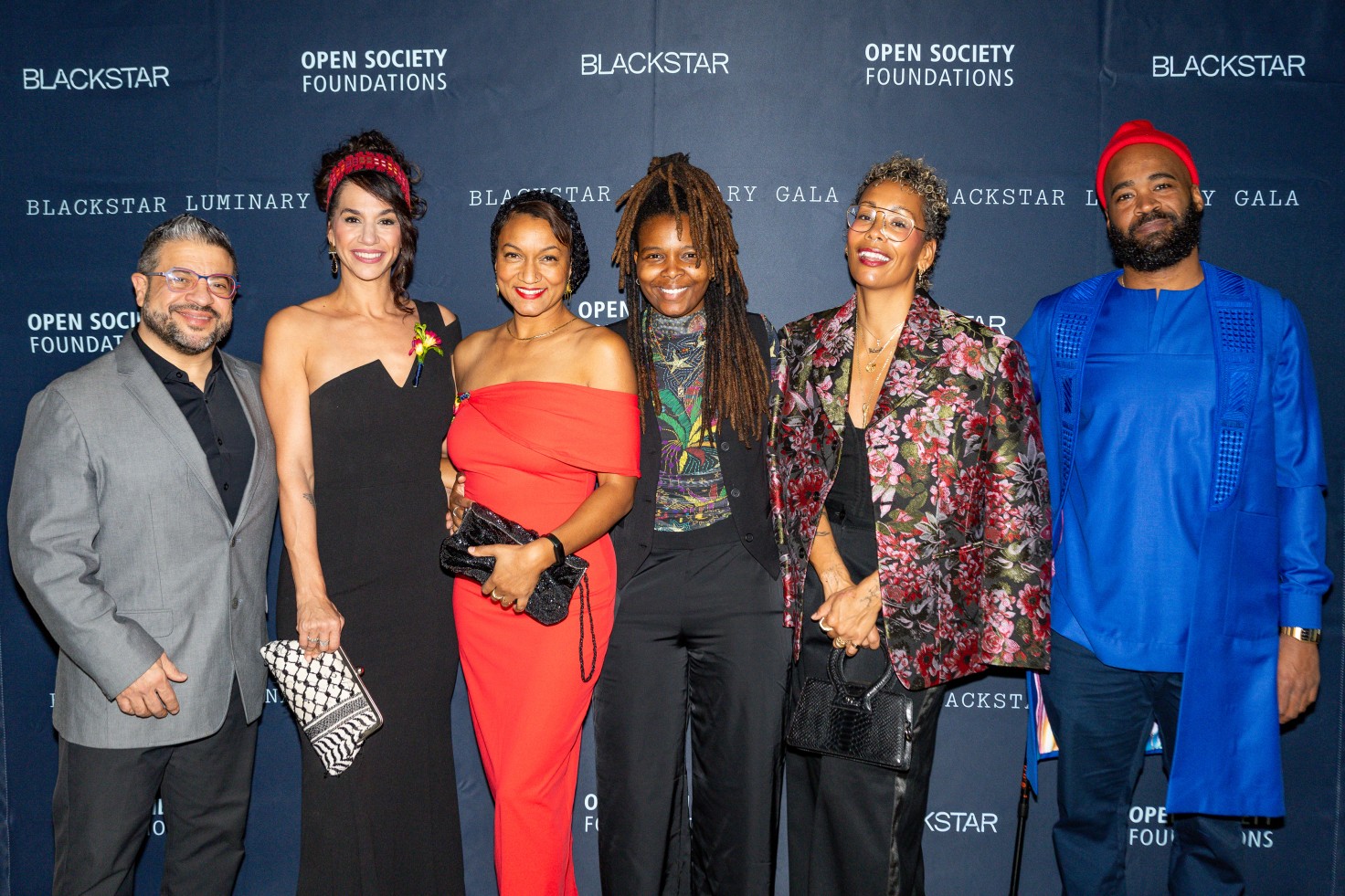 A photo of six people standing against a backdrop that reads BlackStar, Open Society Foundations, BlackStar Luminary Gala.
