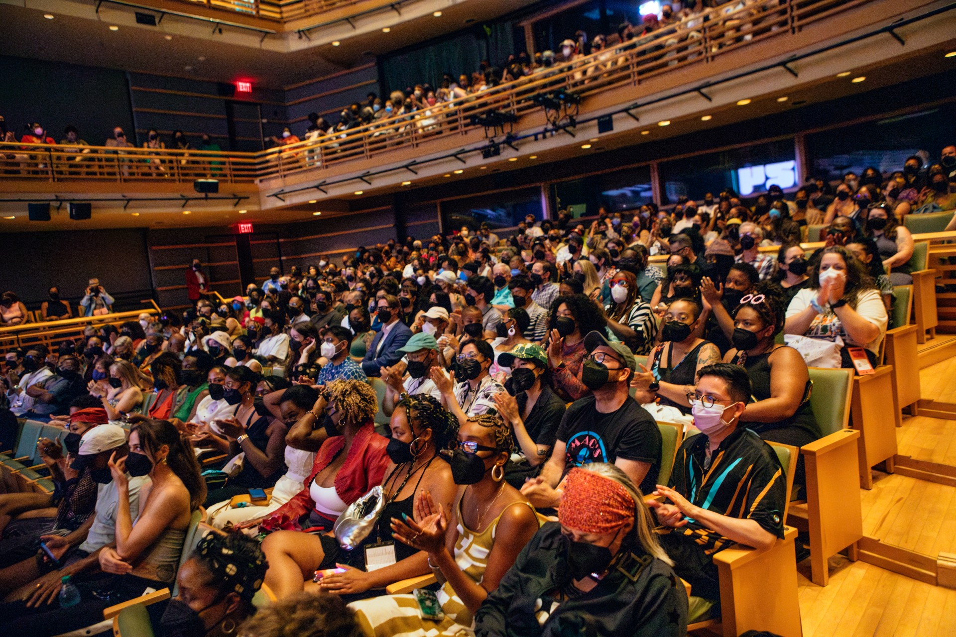 A photo of a crowd watching a film, masks on, at BlackStar Film Festival inside the Kimmel Center.
