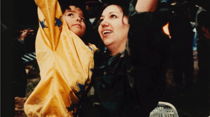 A woman and child put their fists in the air triumphantly in a still from “Kanehsatake: 270 Years of Resistance.”