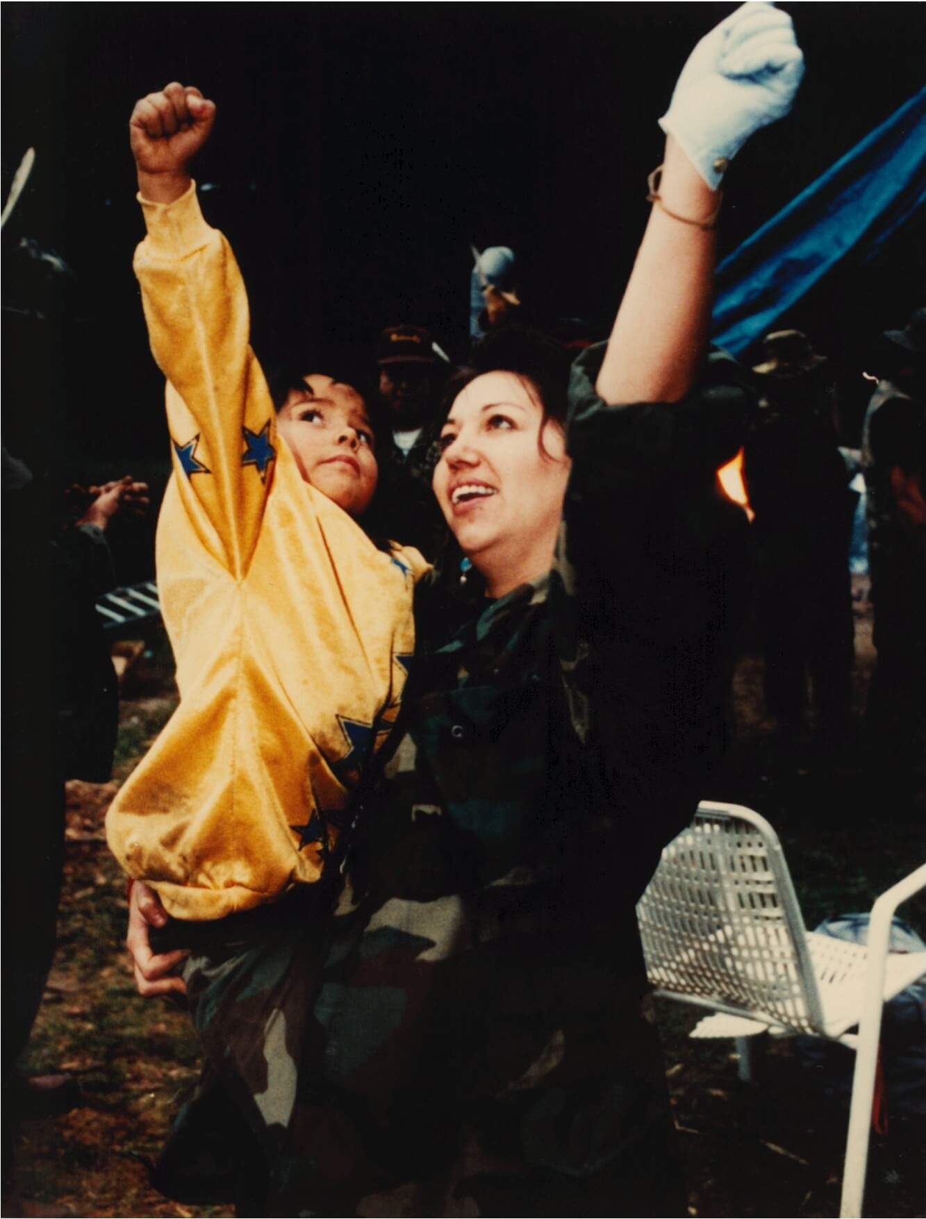 A woman and child put their fists in the air triumphantly in a still from “Kanehsatake: 270 Years of Resistance.”