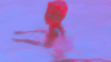 A hot pink and light purple dual-toned film still from nobody’s word shows a figure presumably standing in a body of water looking over their shoulder. The bottom of the still reads: “500 years ago…wow.” in small white text.