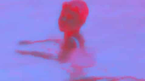 A hot pink and light purple dual-toned film still from nobody’s word shows a figure presumably standing in a body of water looking over their shoulder. The bottom of the still reads: “500 years ago…wow.” in small white text.