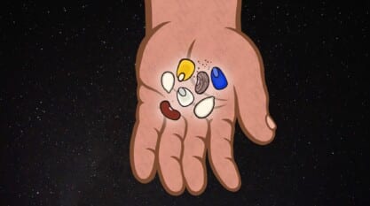 A film still from Kanenon:we–Original Seeds shows a tan cartoon hand pasted over an image of the galaxy. In the palm of the hand are 2 beans, 2 seeds, and 3 kernels of corn.