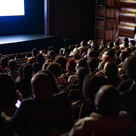 An image of a theater full of people.