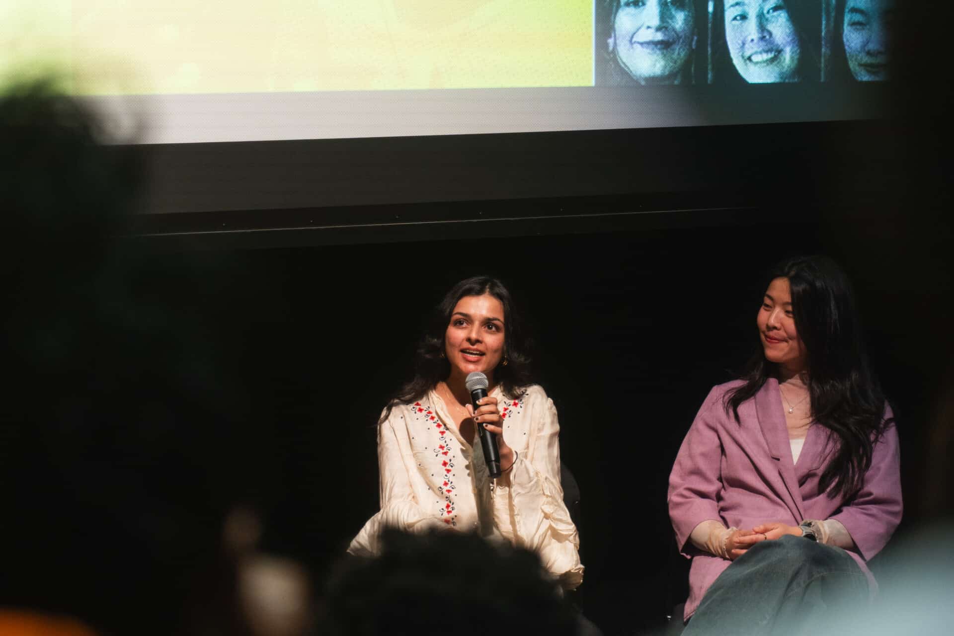A photo of two people on stage at the 2025 William and Louise Greaves Filmmaker Seminar, leading a presentation.
