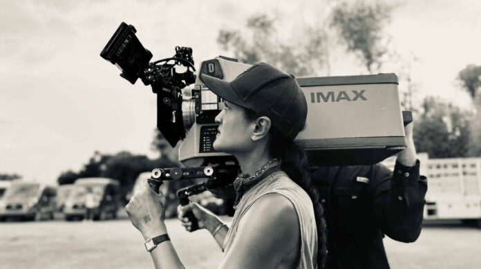 Autumn Durald Arkapaw is holding a film camera.