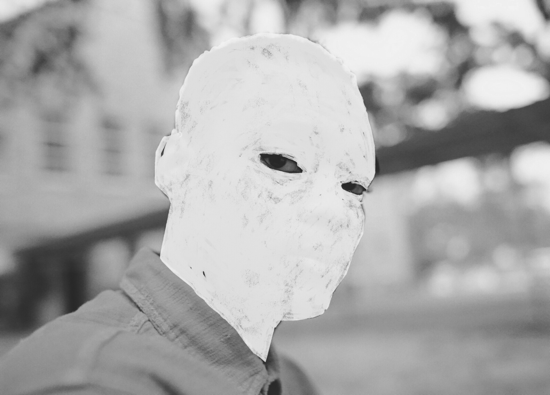 A still from the film Nickel Boys (2024). A black and white close-up of a person with only his eyes visible, his face is whited out.