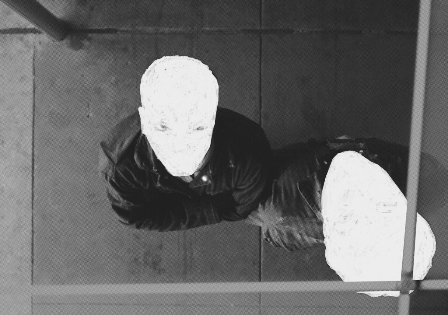 A still from the film Nickel Boys (2024). Two young men looking up, their faces whited out.