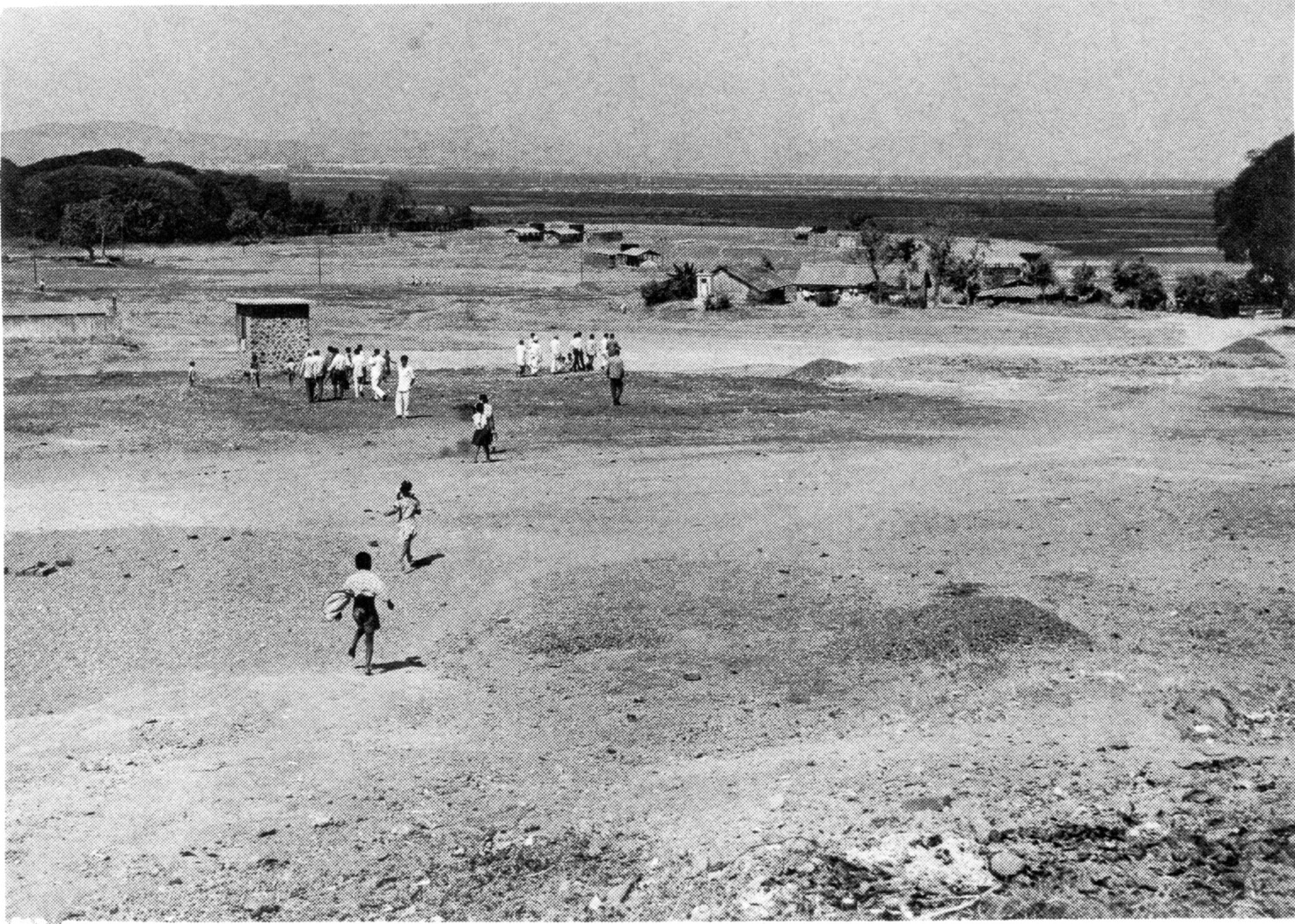 A black and white digital image of groups of people walking in a field