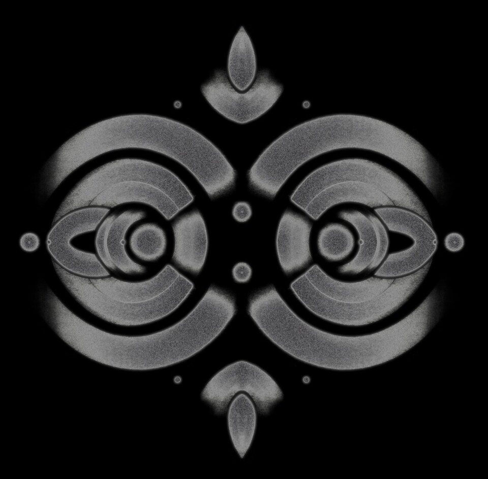 Abstract symmetrical grey patterns of circles create a diamond shape with teardrop-shaped ends on the top and bottom.