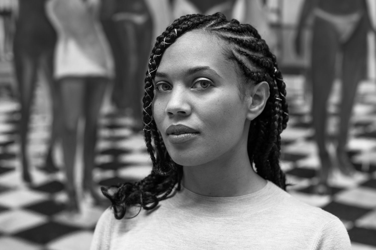 A black-and-white headshot of Onye Anyanwu, she is Black woman. She has braids. She is looking softy at the camera.