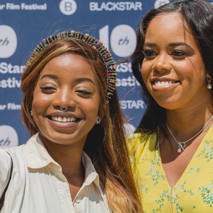 Two Black people pose for a selfie at the 10th BlackStar Film Festival (logo visible in the background)