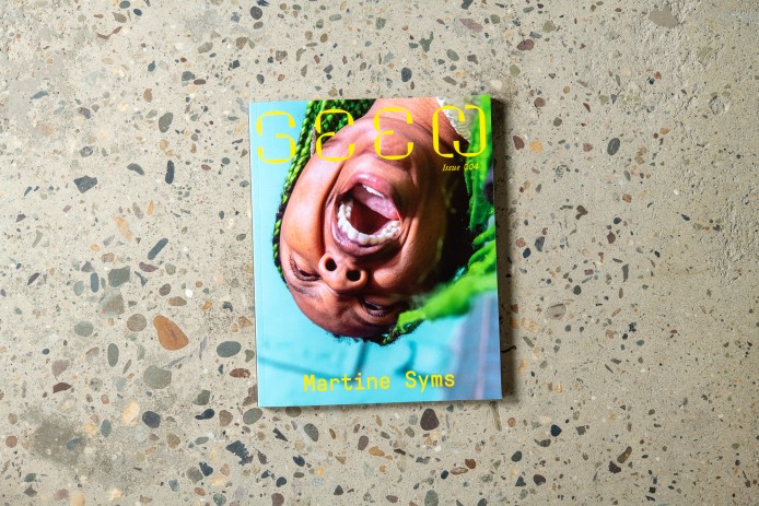 Photo of Seen Issue 004 cover shows Martine Syms screaming upside down, her name and the magazine title in yellow. She wears green braids.