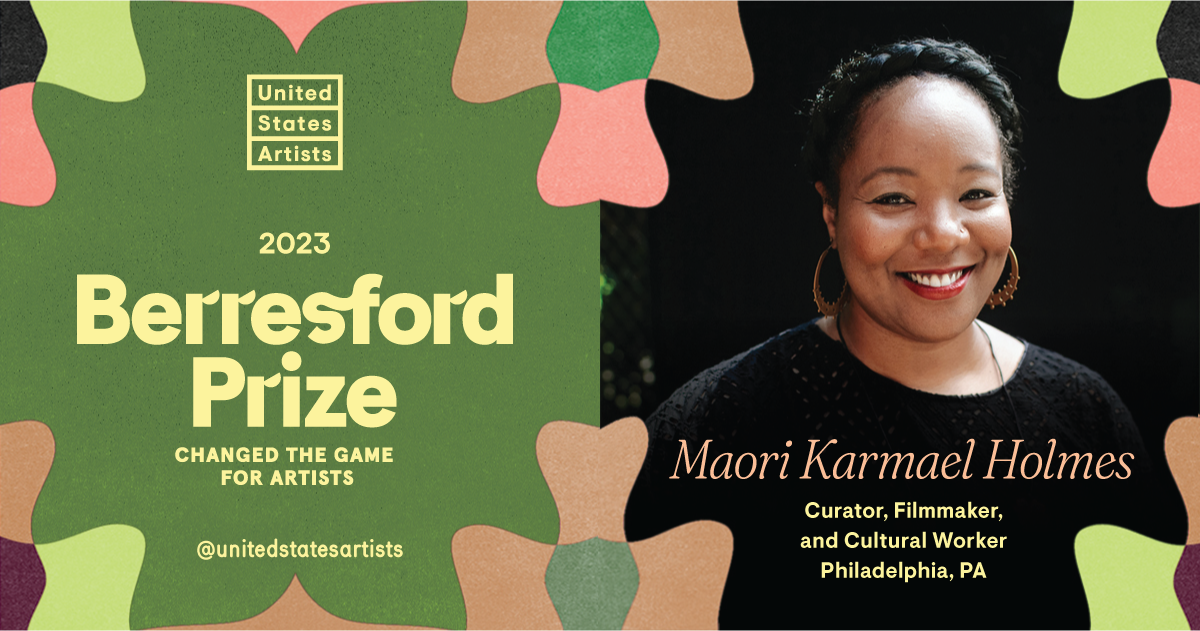 Bold text at the center of an abstract green and pink floral pattern reads “United States Artists 2023 Berresford Prize: Changed the Game for Artists” next to a photo of Maori Karmael Holmes, a Black woman with a braided updo, smiling at the camera. Additional text reads “Maori Karmael Holmes, Curator, Filmmaker, and Cultural Worker, Philadelphia, PA.